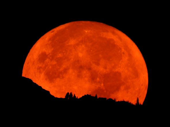 October full orange moon setting from Mt. Rainier